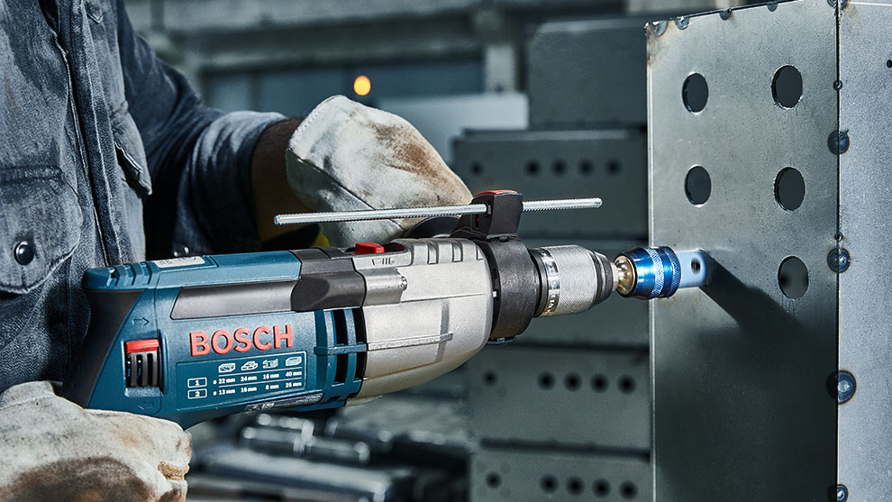 A Bosch Professional cordless tool is being used on a metal piece.